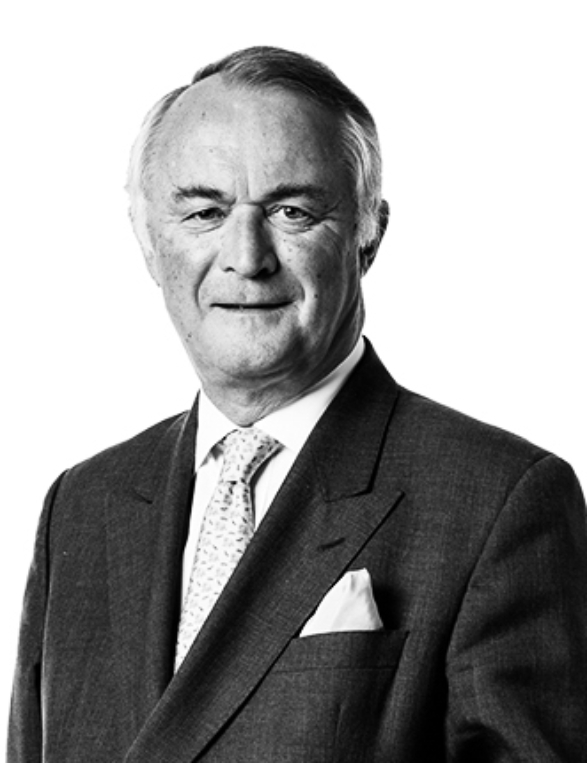 A black and white headshot of Stephen Catlin, who is wearing a suit and tie with a white pocket square