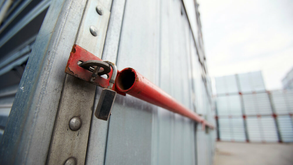 A close up of the padlock on a shipping container, it's unlocked.